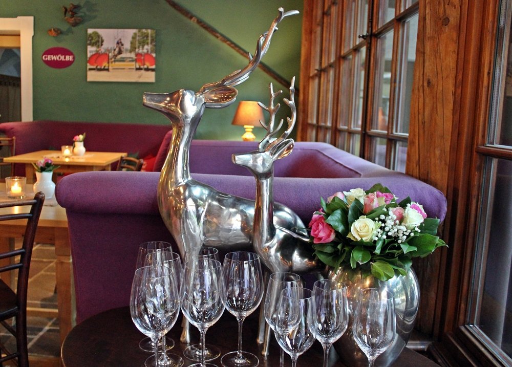 Hirsche vor einem lila Sofa,Hauben-Restaurant im Romantik Hotel GMACHL